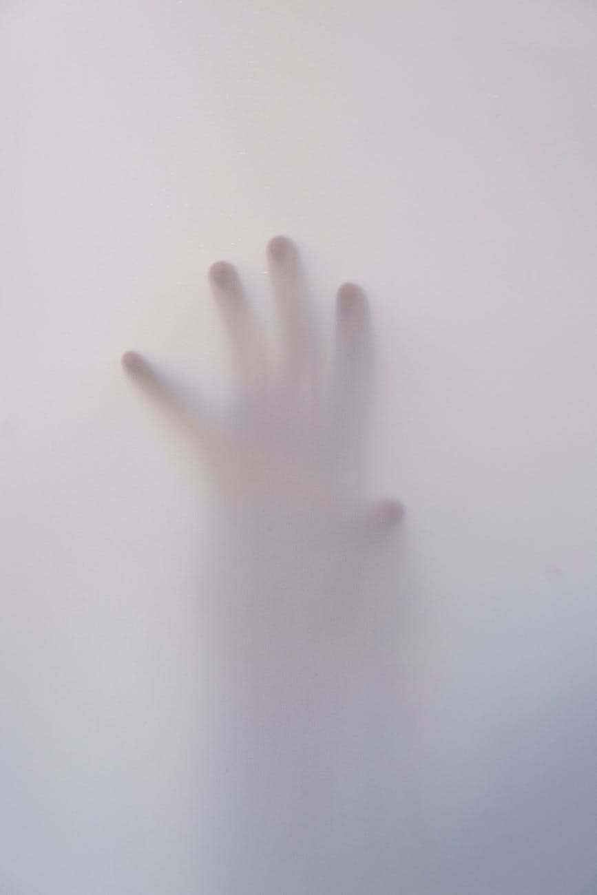 person s hand touching wall